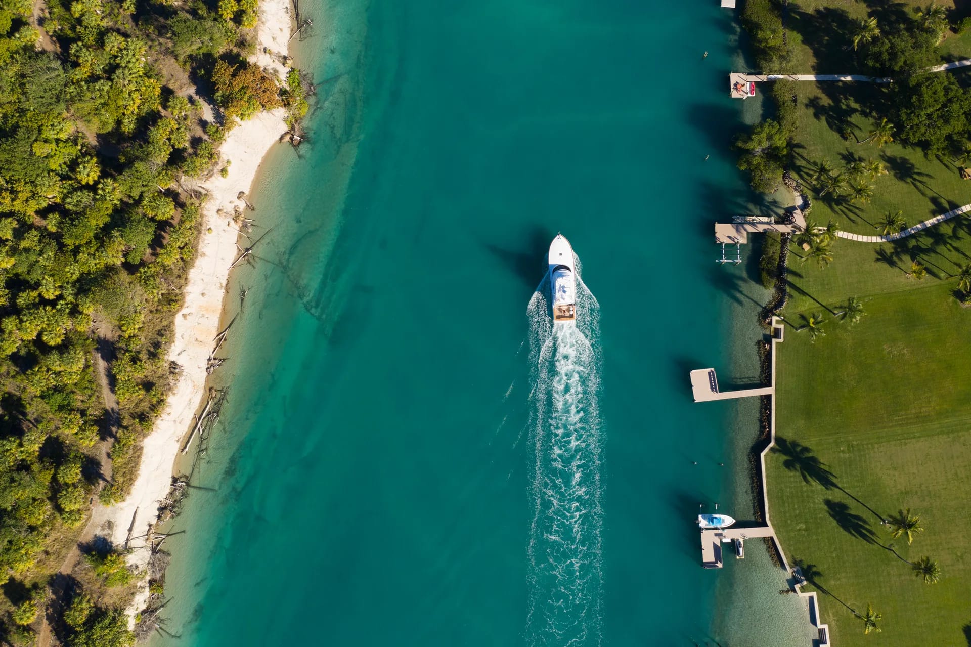 A crew member detailing a boat to yacht-crew standards at a private Florida dock